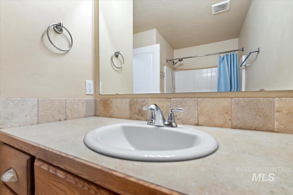 1838 Ridge Way Middleton, ID 83644 - Photo 24 of 42 Bathroom with vanity and a shower with shower curtain