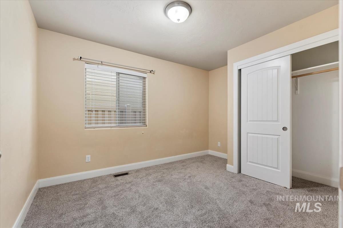 1838 Ridge Way Middleton, ID 83644 - Photo 26 of 42 Unfurnished bedroom featuring light carpet and a closet