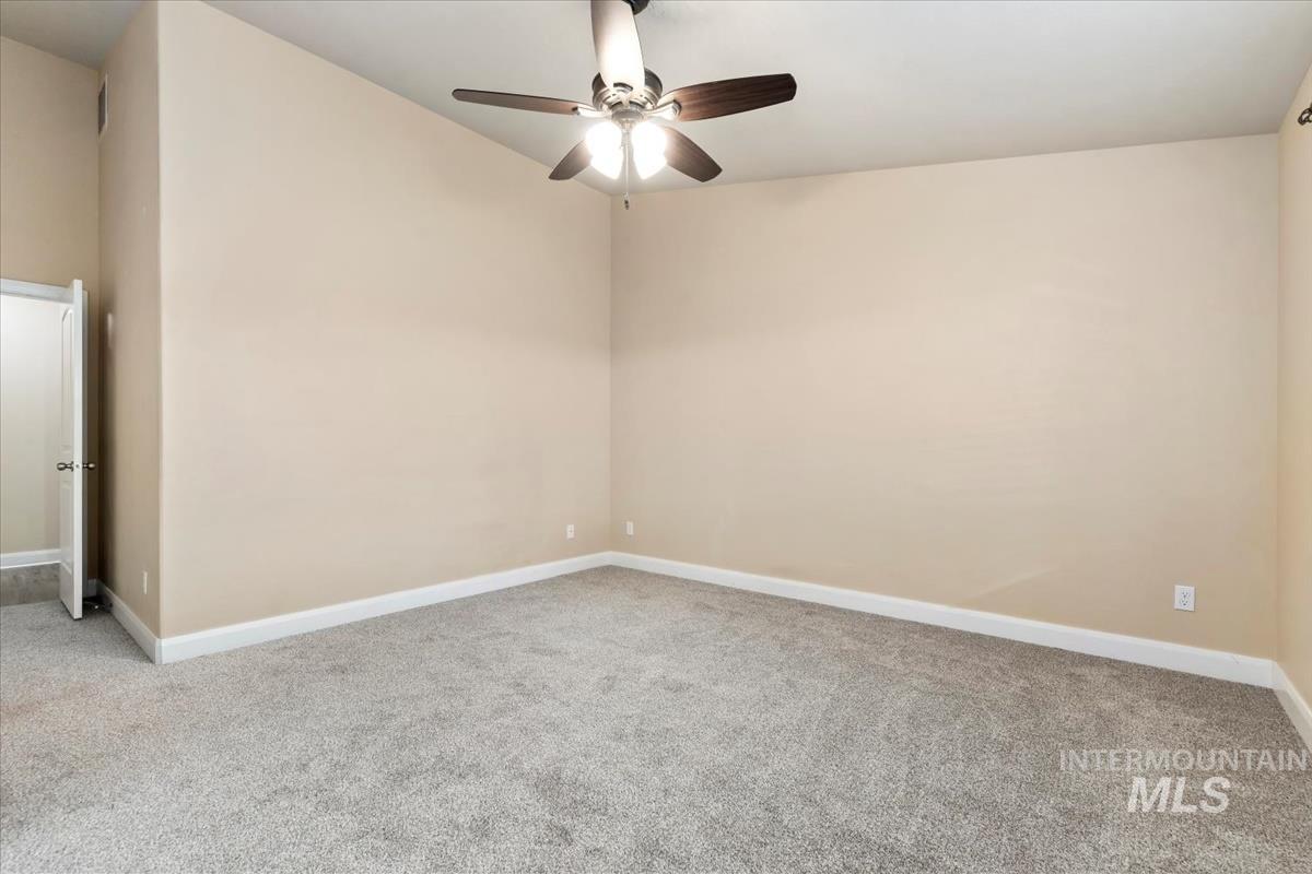 1838 Ridge Way Middleton, ID 83644 - Photo 28 of 42 Empty room with light colored carpet and a ceiling fan