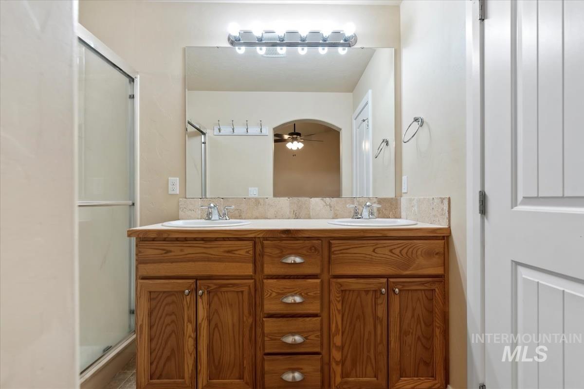 1838 Ridge Way Middleton, ID 83644 - Photo 31 of 42 Bathroom with double vanity, a stall shower, and ceiling fan