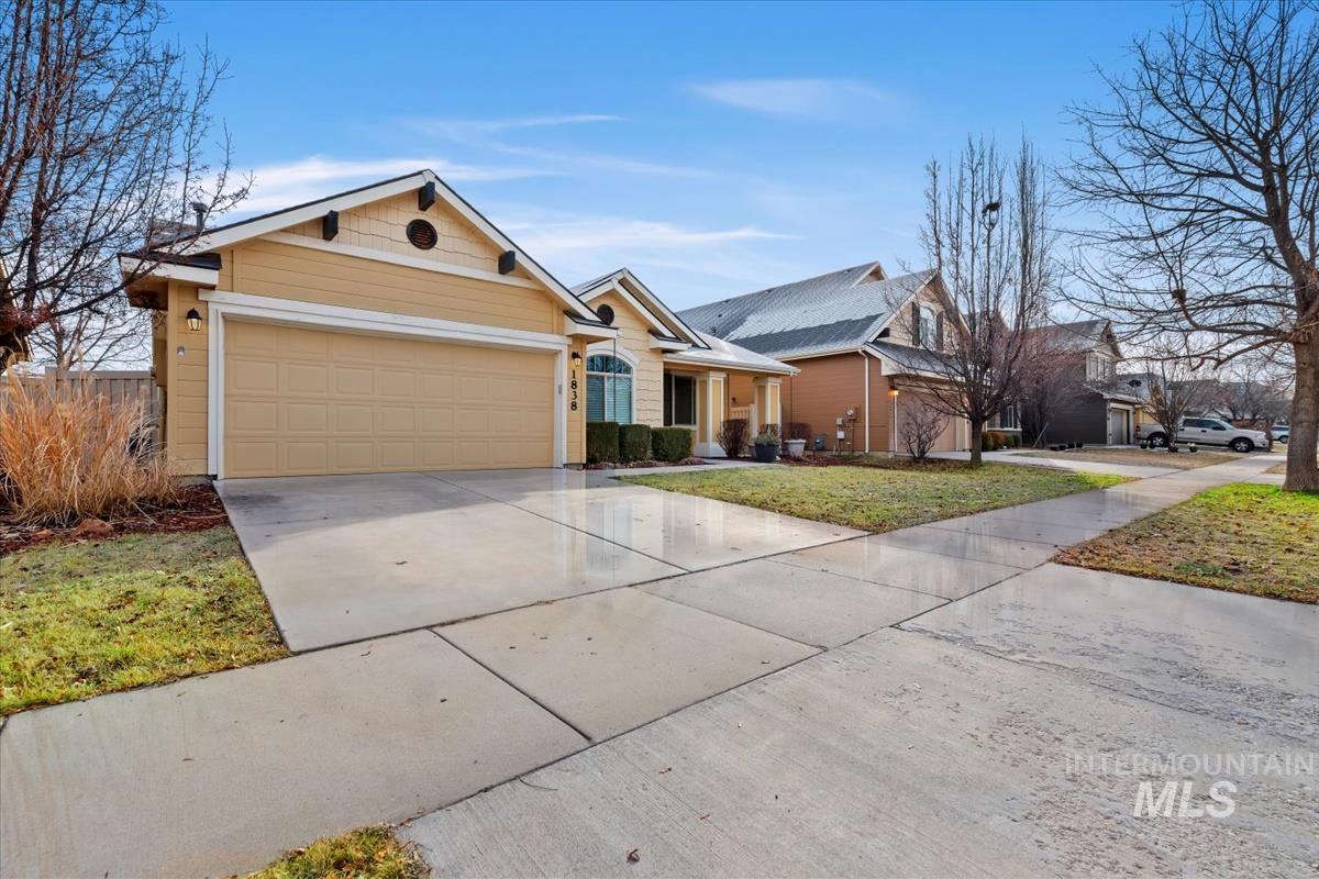 1838 Ridge Way Middleton, ID 83644 - Photo 42 of 42 View of front of house with concrete driveway, covered porch, a garage, and a front yard