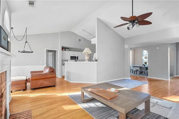 a living room with furniture and a wooden floor