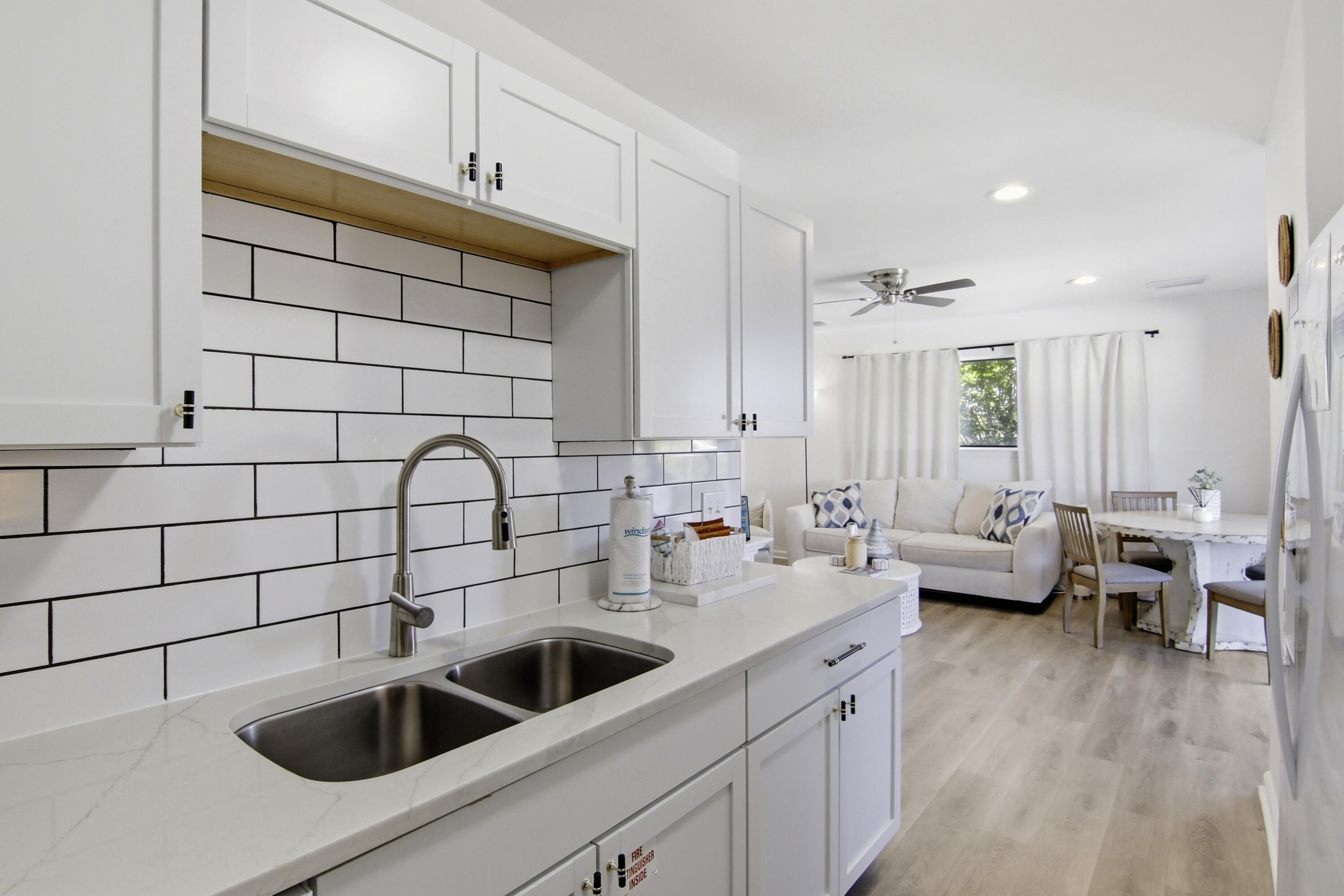 64 Cross Creek Road, Unit 28D Miramar Beach, FL 32550 - Photo 18 of 34 a kitchen with a sink and a white cabinets