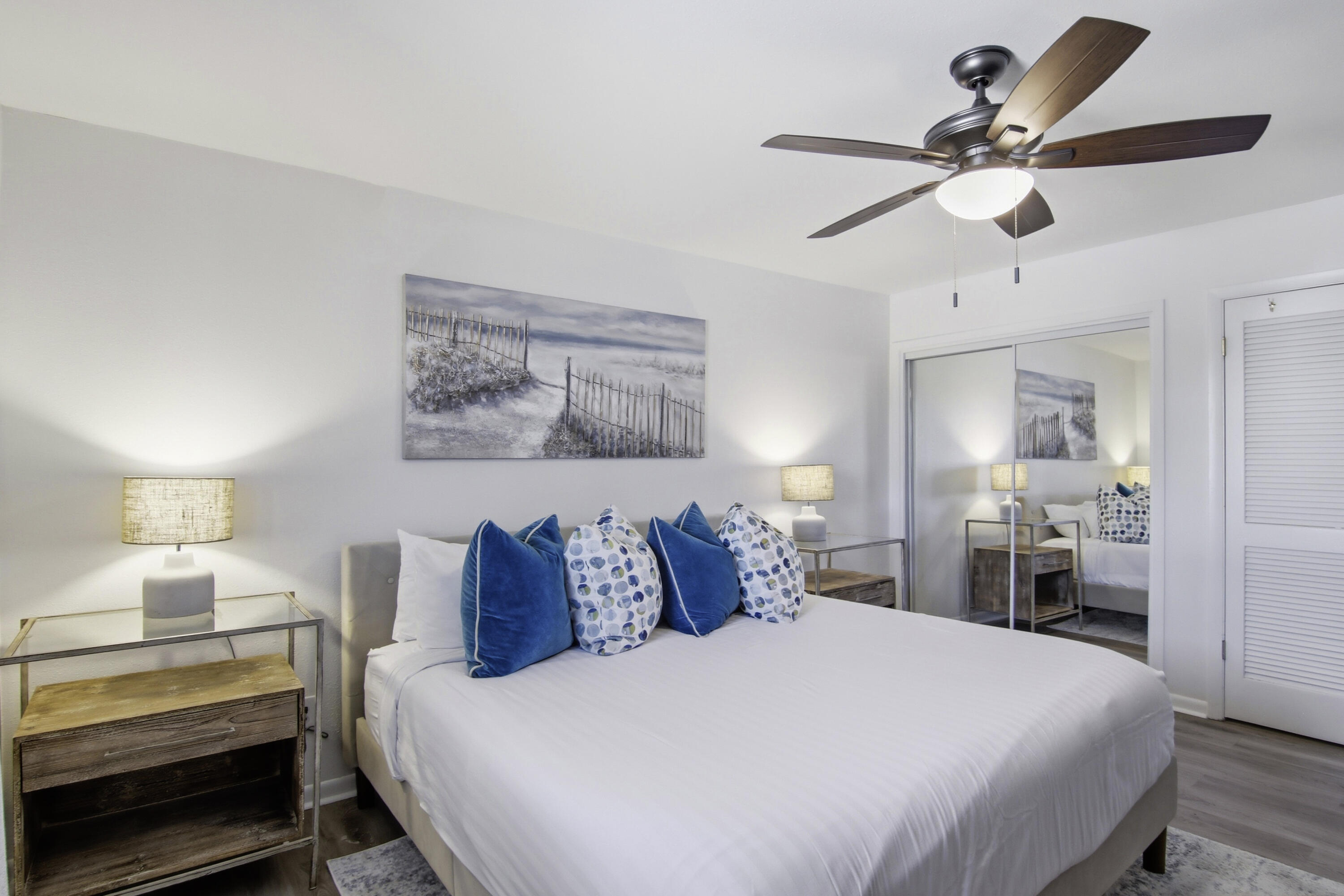 64 Cross Creek Road, Unit 28D Miramar Beach, FL 32550 - Photo 23 of 34 a bedroom with a bed and a chandelier