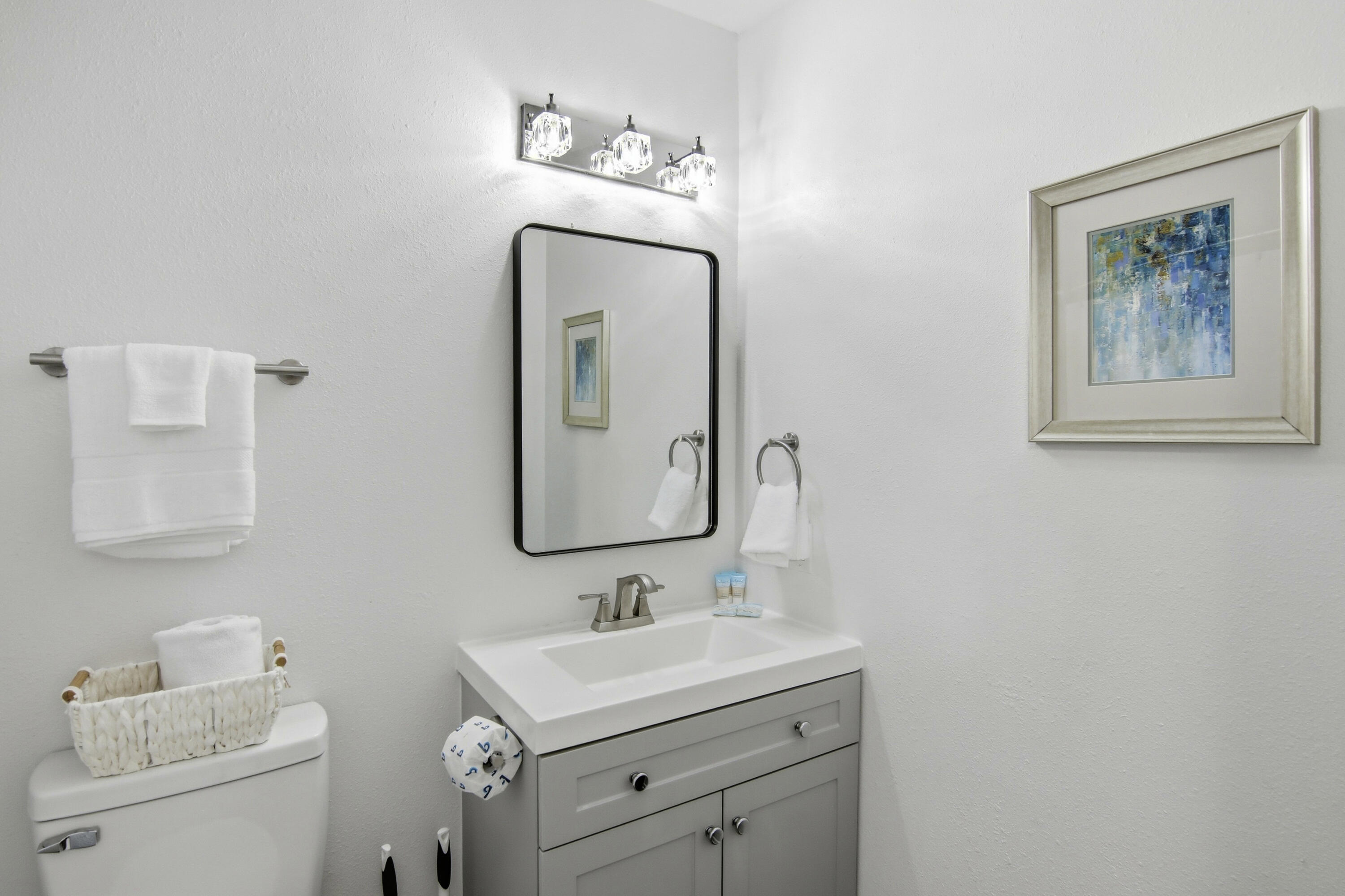 64 Cross Creek Road, Unit 28D Miramar Beach, FL 32550 - Photo 24 of 34 a bathroom with a toilet sink and mirror