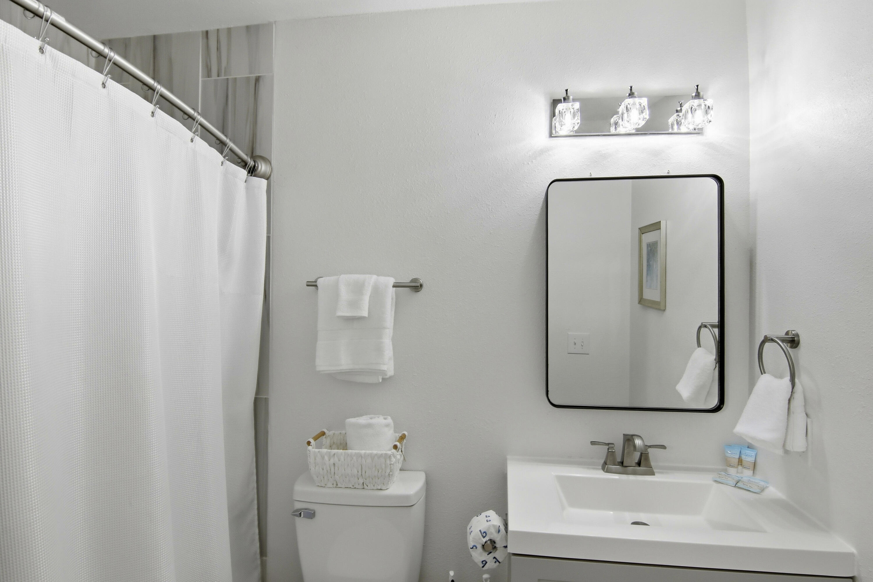 64 Cross Creek Road, Unit 28D Miramar Beach, FL 32550 - Photo 25 of 34 a bathroom with a toilet sink and mirror