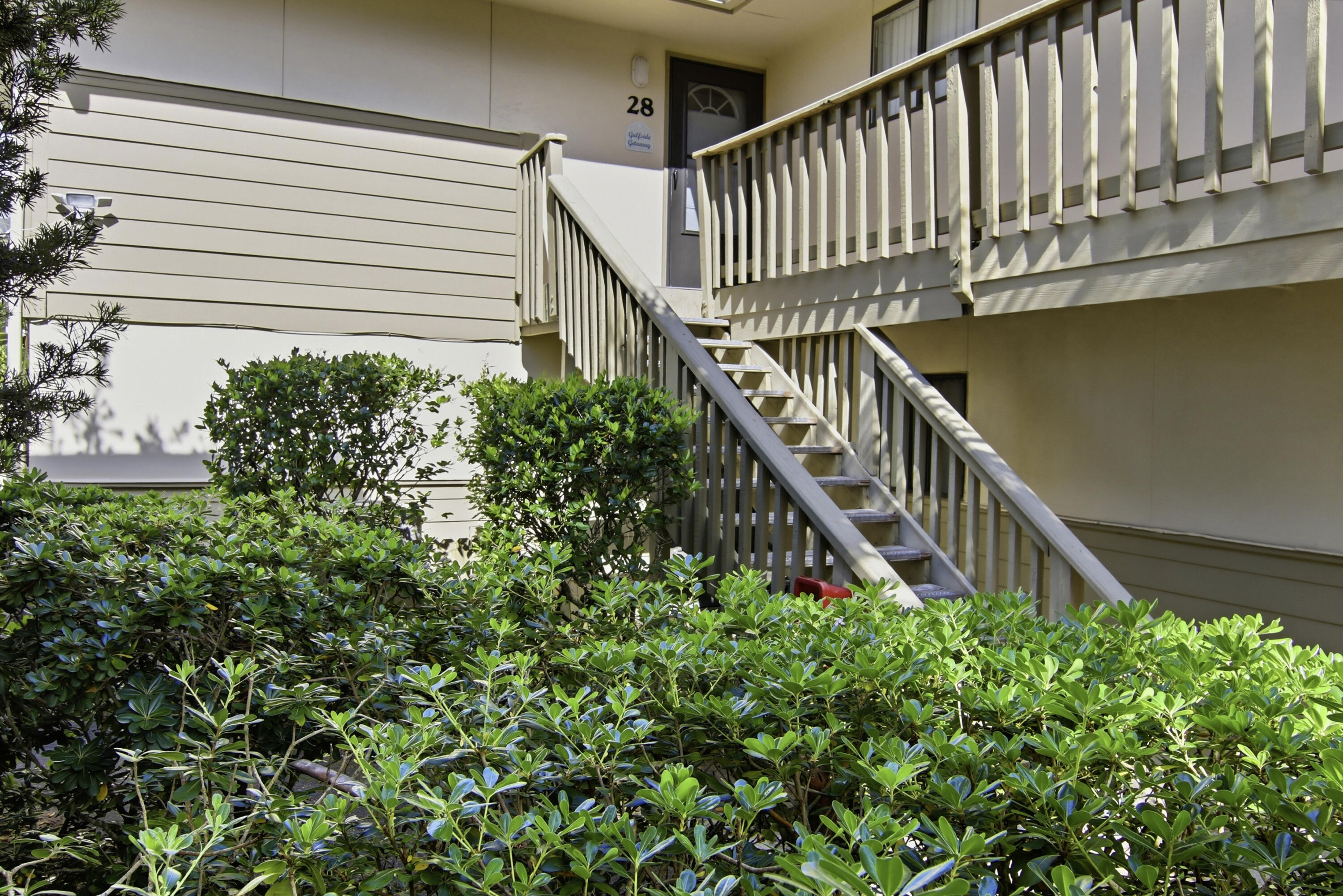 64 Cross Creek Road, Unit 28D Miramar Beach, FL 32550 - Photo 7 of 34 a stairs of a house with flower plants in front of it
