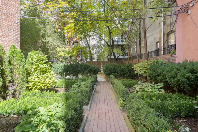 a view of a chair and tables in the patio with potted plants