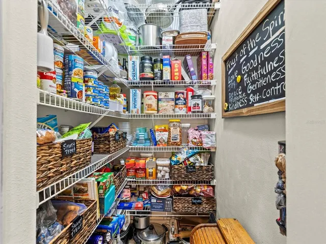 a view of a dining room with furniture and a chandelier