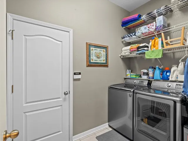 a bedroom with a bed and painting on the wall