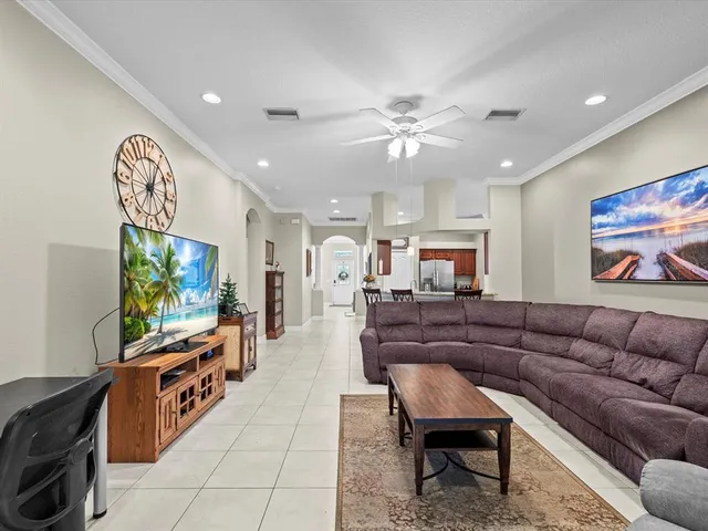 a bedroom with a bed and a ceiling fan