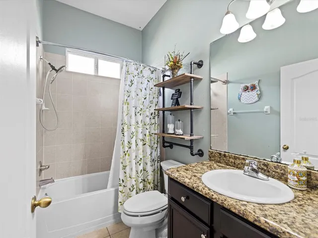 a view of a hallway with a cabinet and a living room