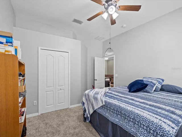 a view of a house with potted plants and a large tree