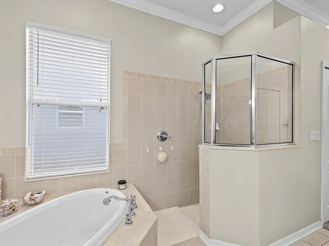 a living room with furniture and floor to ceiling windows
