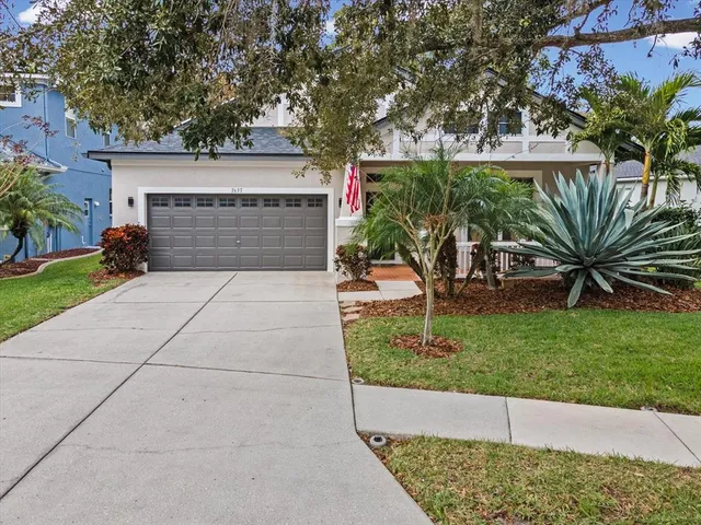 a backyard of a house with a fountain table and chairs