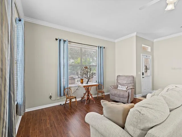 a dining room with furniture and wooden floor