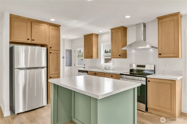 a kitchen with stainless steel appliances granite countertop a sink stove and refrigerator