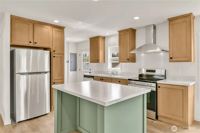 a kitchen with stainless steel appliances granite countertop a sink stove and refrigerator