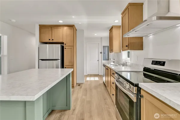 a kitchen with granite countertop a sink stainless steel appliances and cabinets