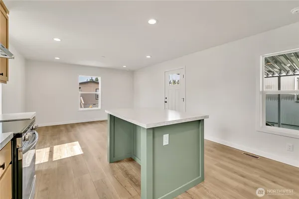 a view of a kitchen with a refrigerator and a sink