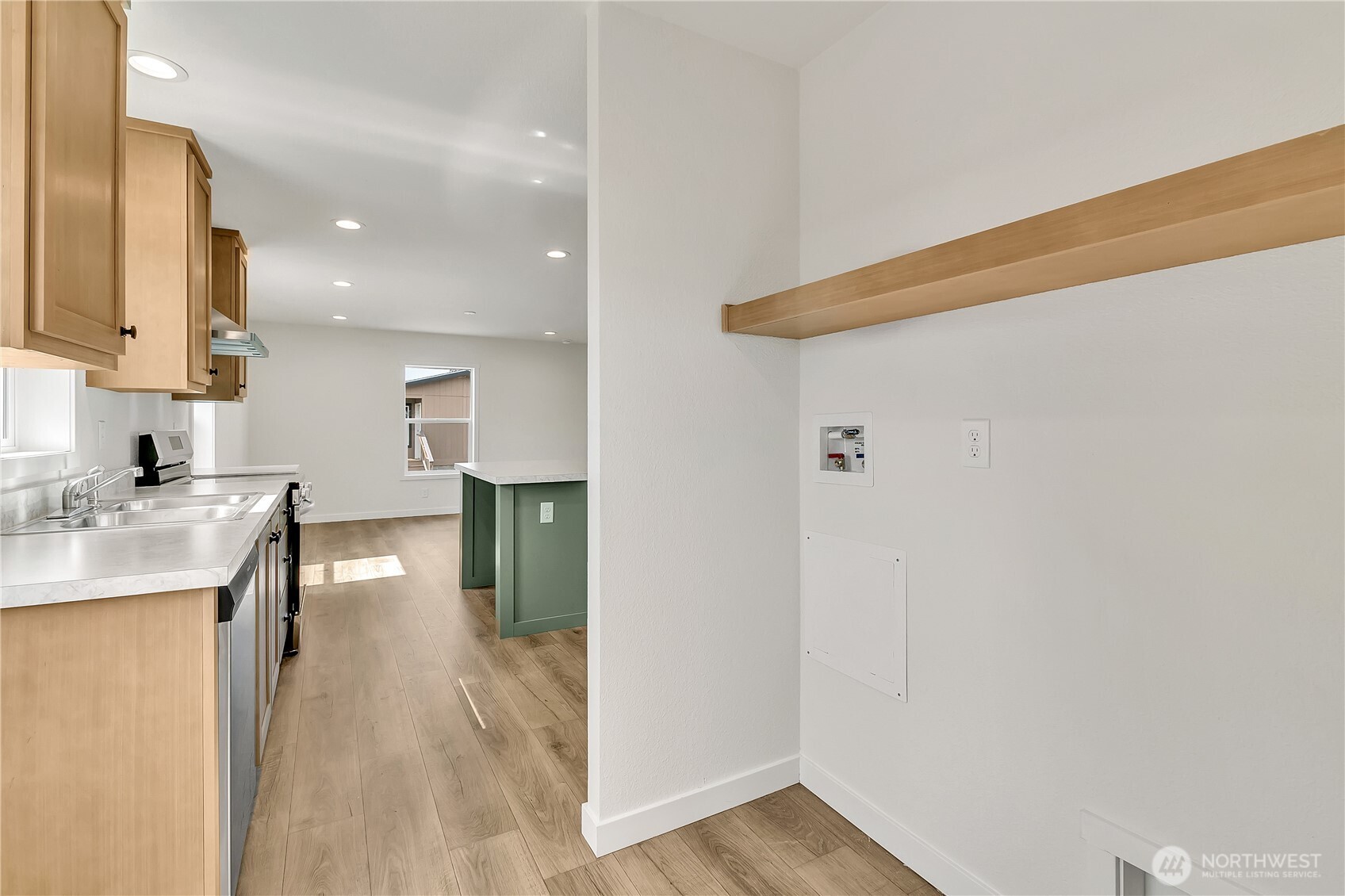 3237 South 182nd Place, Unit 221 SeaTac, WA 98188 - Photo 10 of 14 a view of a kitchen with a refrigerator and a sink