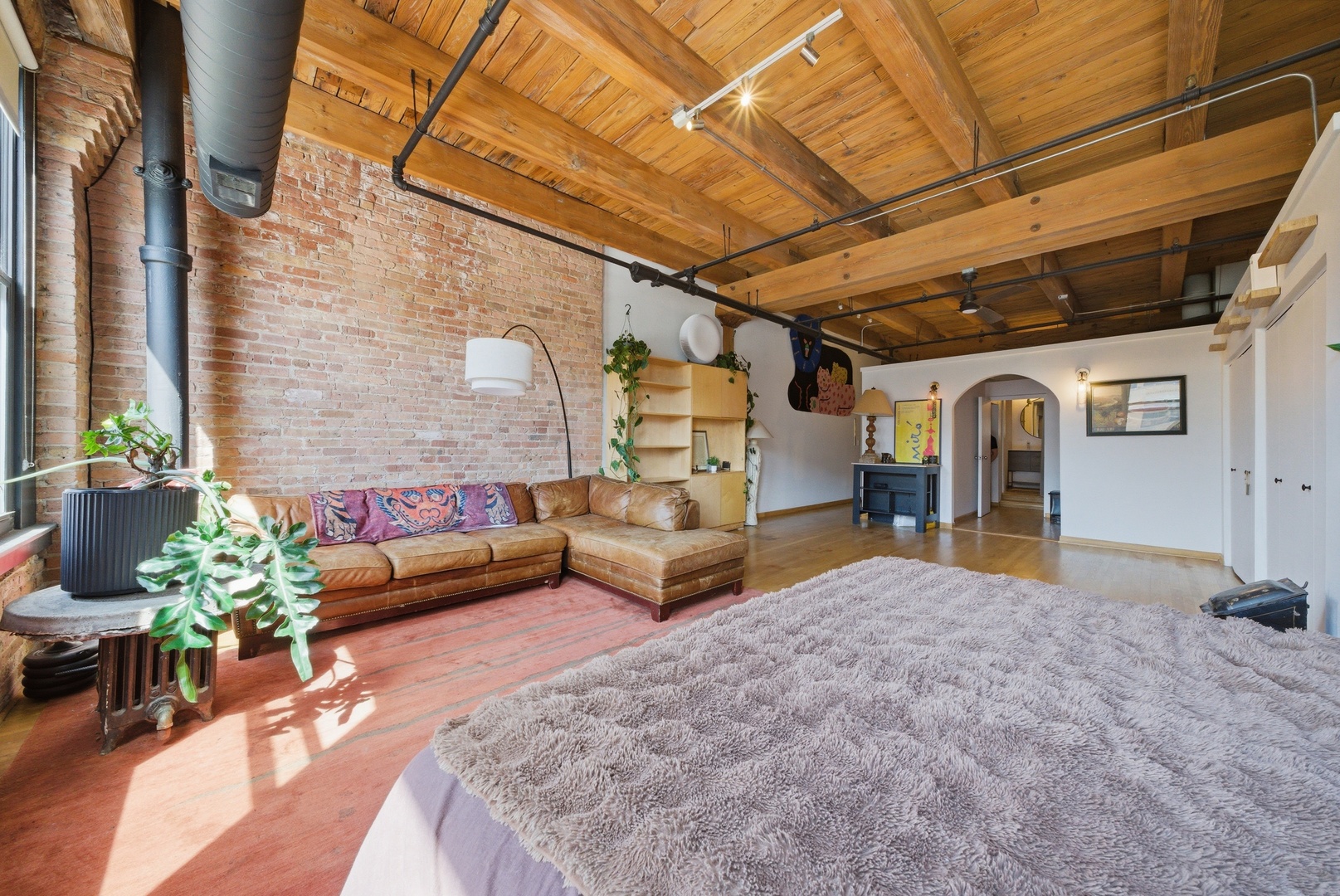 400 South Green Street, Unit 310 Chicago, IL 60607 - Photo 15 of 43 a bedroom with furniture and a wooden floor