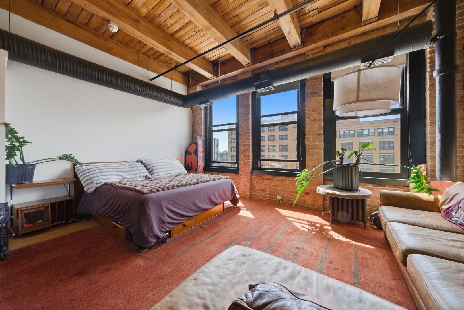400 South Green Street, Unit 310 Chicago, IL 60607 - Photo 37 of 43 a spacious bedroom with a bed a table and chair