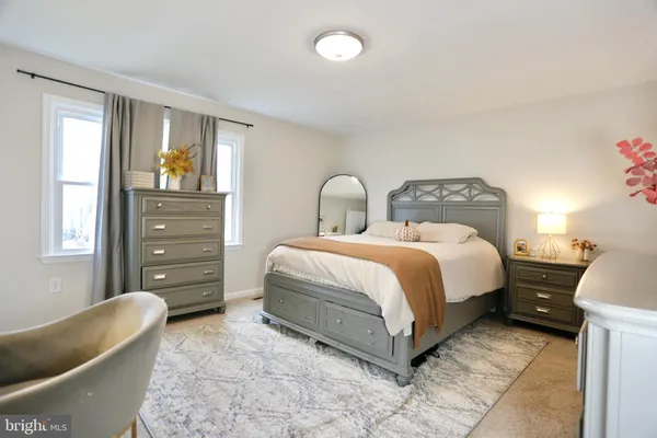 a bedroom with a bed and a couch