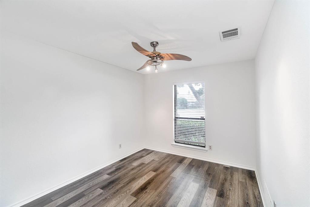 1905 Lansdown Court Carrollton, TX 75010 - Photo 12 of 23 an empty room with a window and a ceiling fan