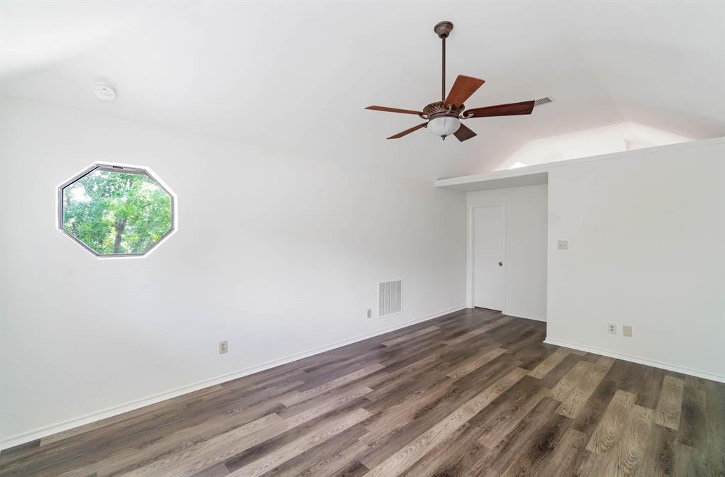 1905 Lansdown Court Carrollton, TX 75010 - Photo 16 of 23 an empty room with wooden floor ceiling fan