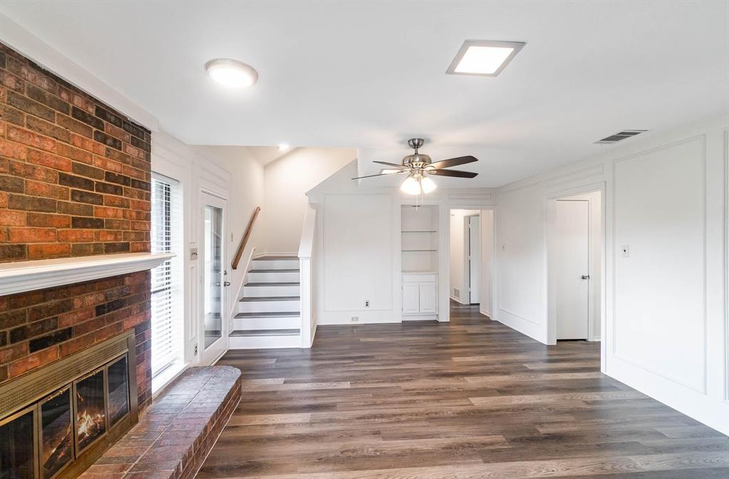 1905 Lansdown Court Carrollton, TX 75010 - Photo 19 of 23 wooden floor in an empty room with a fireplace
