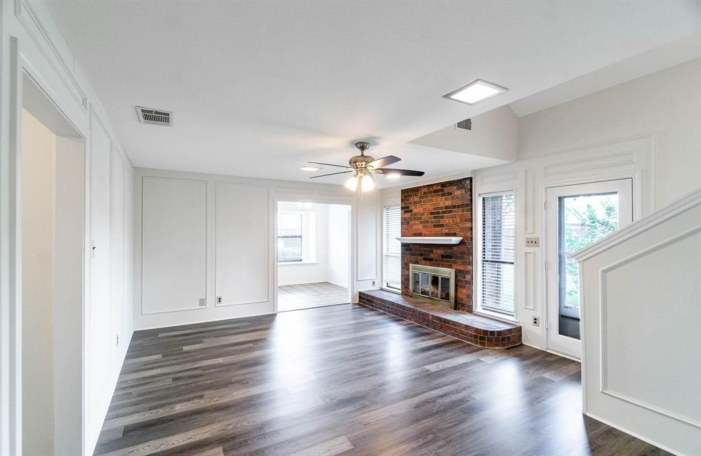 1905 Lansdown Court Carrollton, TX 75010 - Photo 20 of 23 an empty room with wooden floor fireplace and windows