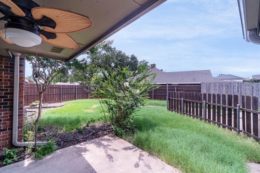 1905 Lansdown Court Carrollton, TX 75010 - Photo 21 of 23 a view of a backyard with plants and a patio