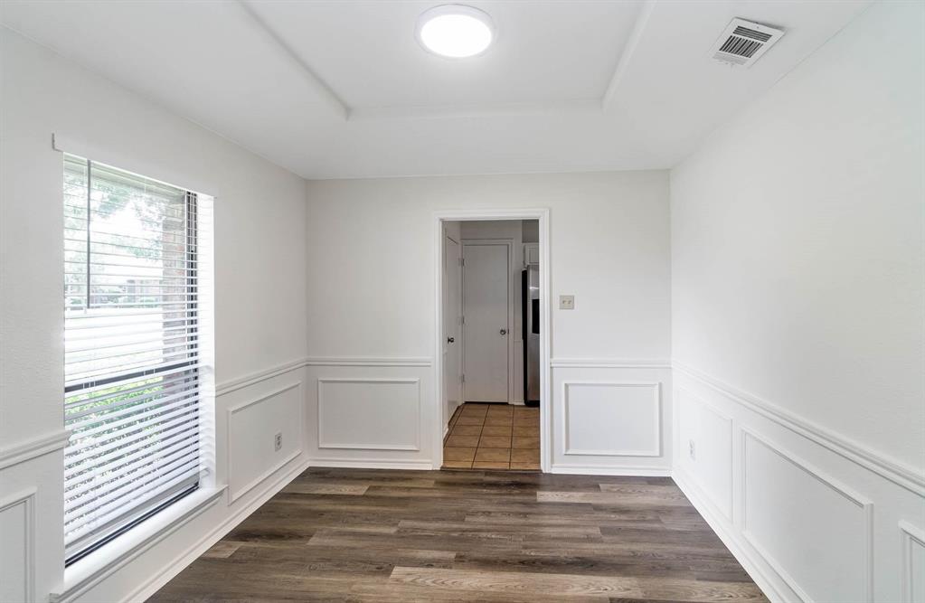 1905 Lansdown Court Carrollton, TX 75010 - Photo 5 of 23 a view of an empty room with wooden floor and a window
