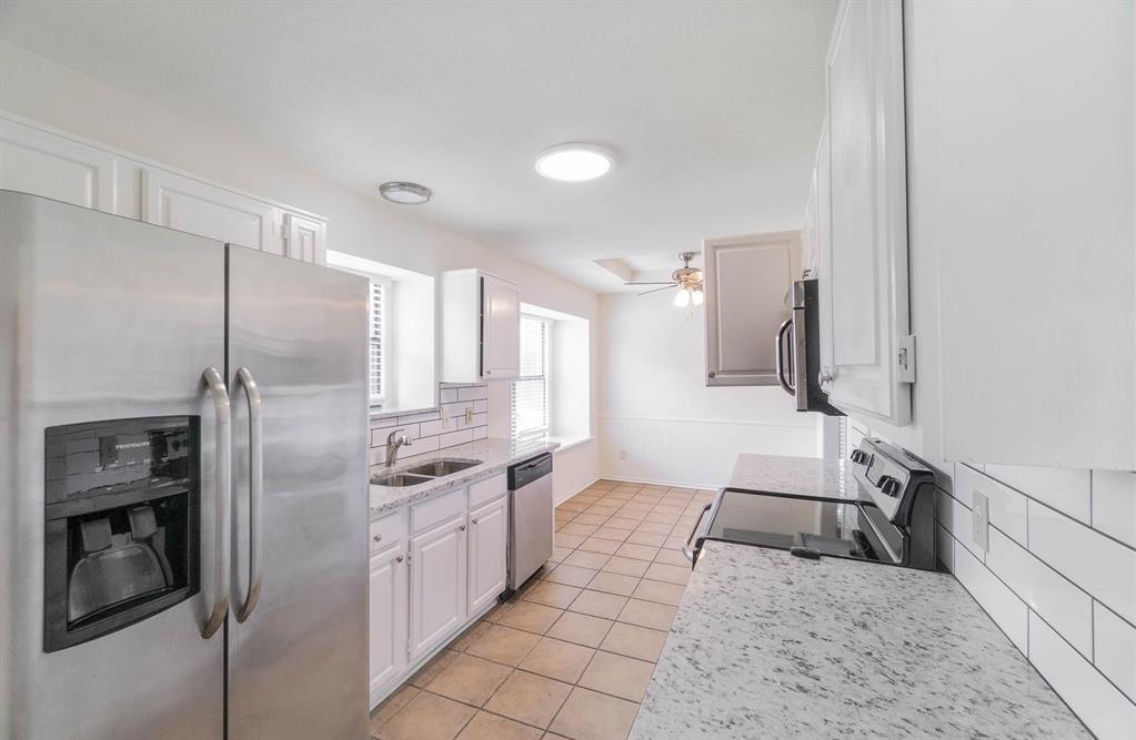 1905 Lansdown Court Carrollton, TX 75010 - Photo 6 of 23 a kitchen with stainless steel appliances granite countertop a refrigerator and a sink