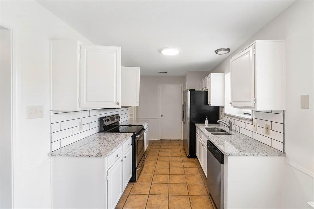 1905 Lansdown Court Carrollton, TX 75010 - Photo 7 of 23 a kitchen with stainless steel appliances granite countertop a stove top oven a refrigerator a sink and dishwasher