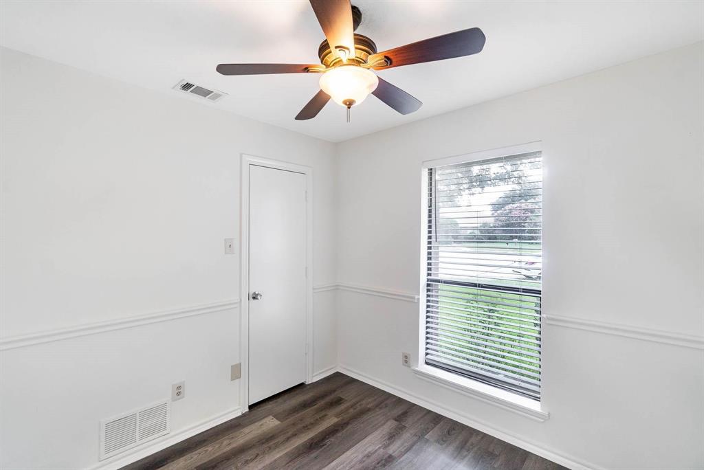 1905 Lansdown Court Carrollton, TX 75010 - Photo 9 of 23 an empty room with windows and fan