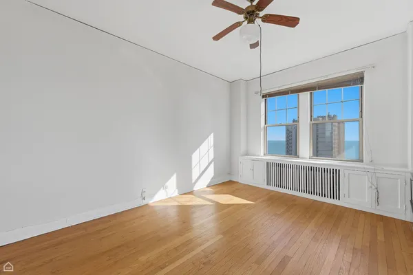 a view of a livingroom with a ceiling fan and window