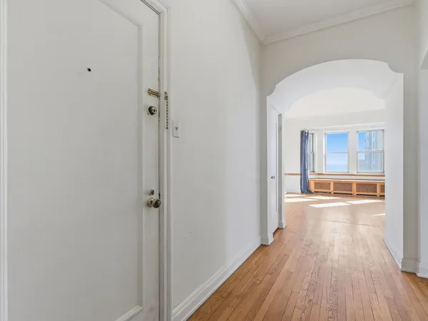 a view of a room with wooden floor