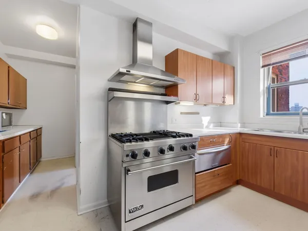 a kitchen with stainless steel appliances granite countertop a stove and a sink