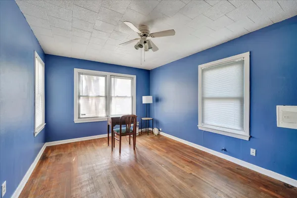 a view of a livingroom with furniture window and wooden floor