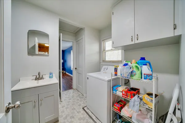 a utility room with fridge dryer and washer