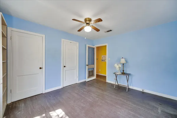 a view of empty room with wooden floor