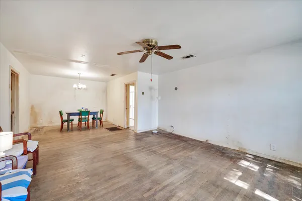 a view of a livingroom with furniture and a ceiling fan