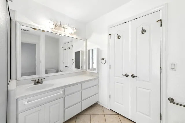 a bathroom with a double vanity sink mirror and shower