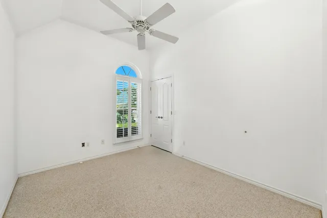 a view of room with a window and a ceiling fan