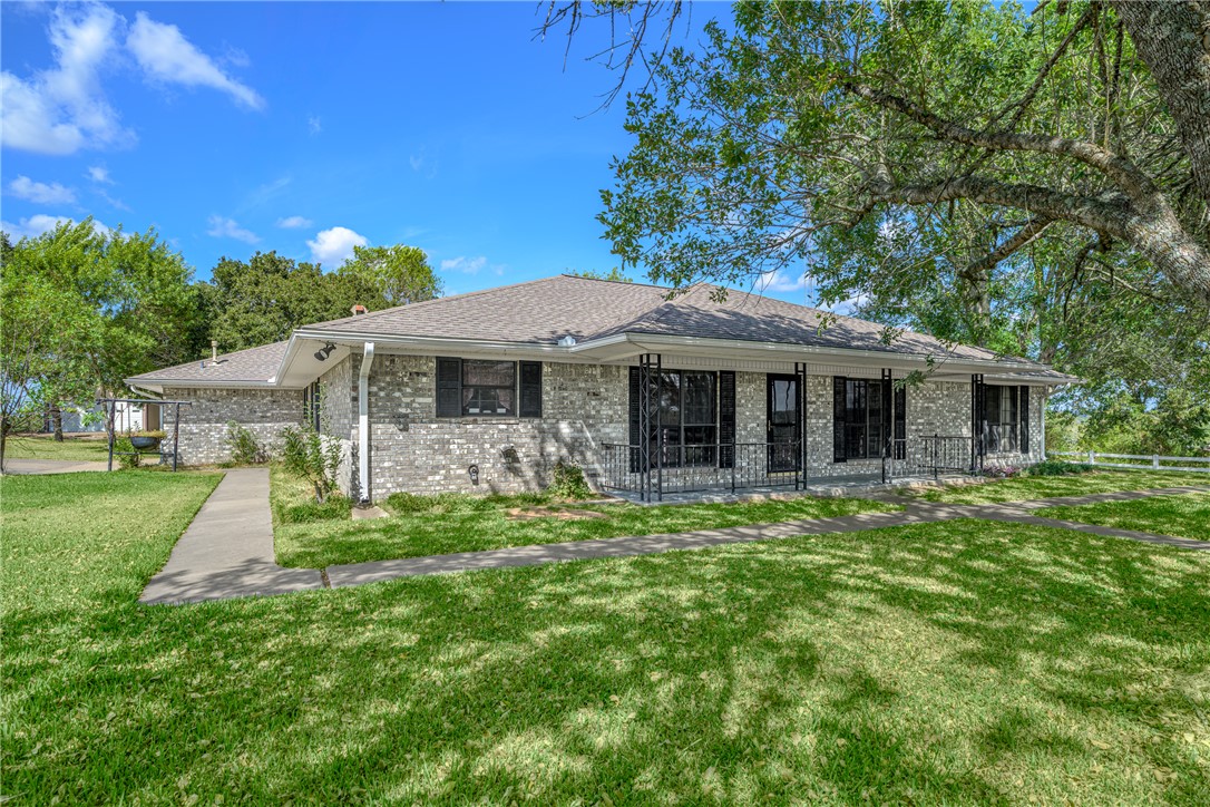6700 FM 332 Road Brenham, TX 77833 - Photo 11 of 36 a front view of a house with a garden