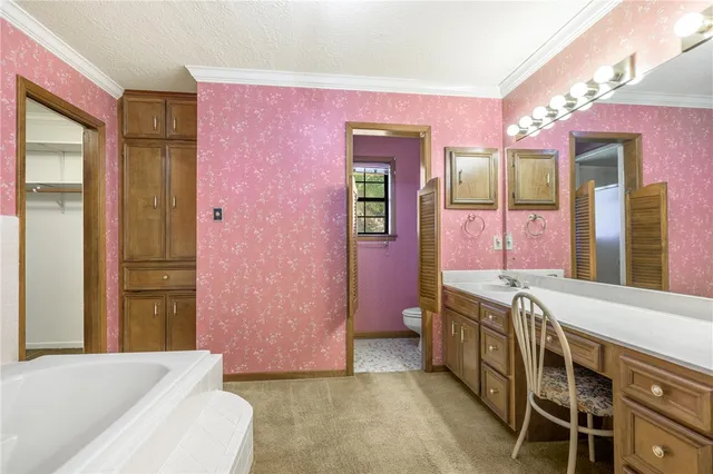 a spacious bathroom with a bathtub sink and mirror