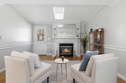 a living room with furniture a window and a fireplace
