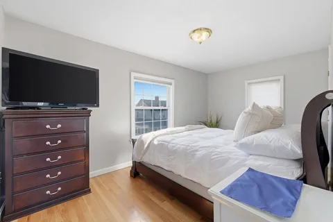a bedroom with a bed and a flat screen tv
